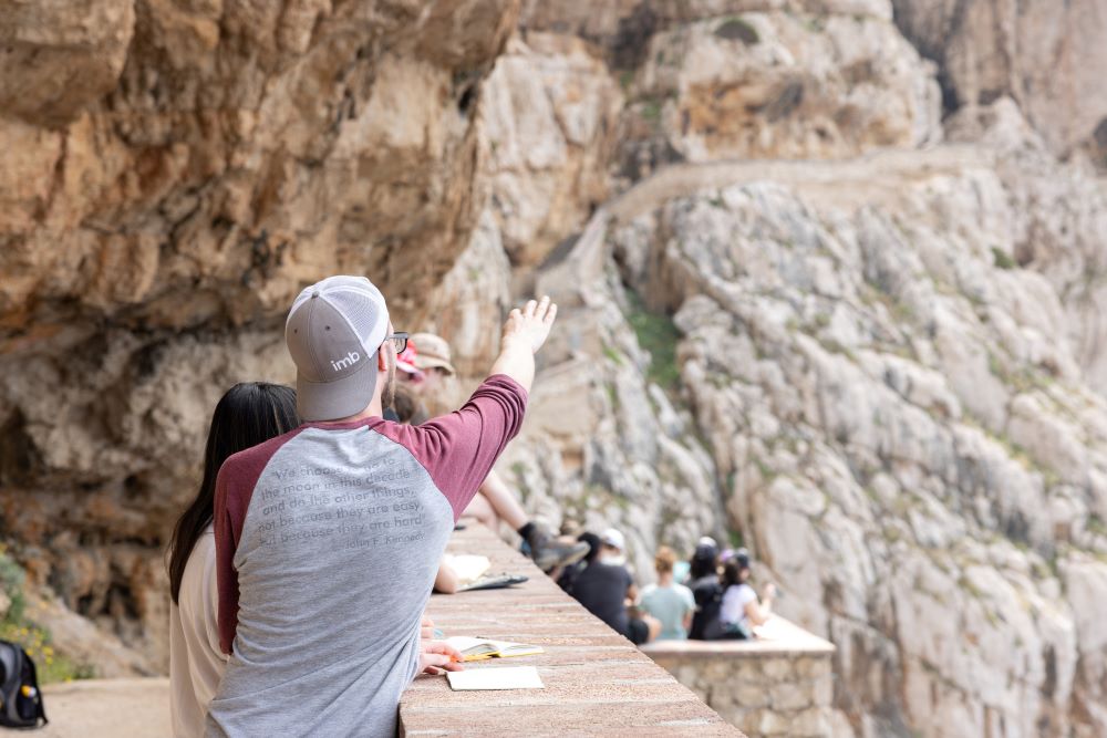 Mark during fieldwork, pointing at something in the distance.