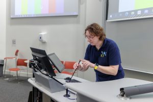 Caroline Carter, AV Installation Manager testing a lecture theatre mic