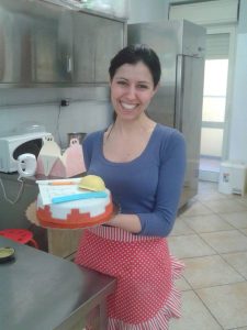 Sara Concas, Junior Developer. Holding a homemade cake