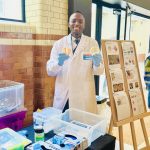 Nana Asante displaying yeast agar plates during his live workshop session at the London Science Museum's Smith Centre