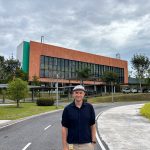Professor Tom Ellis standing outdoors on the VISTEC Institute campus in Rayong, Thailand