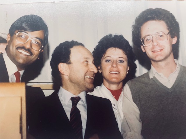 Four people smiling at the camera