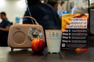 Coffee cup, apple and radio