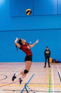 Adriana jumps to reach the ball as she plays volleyball