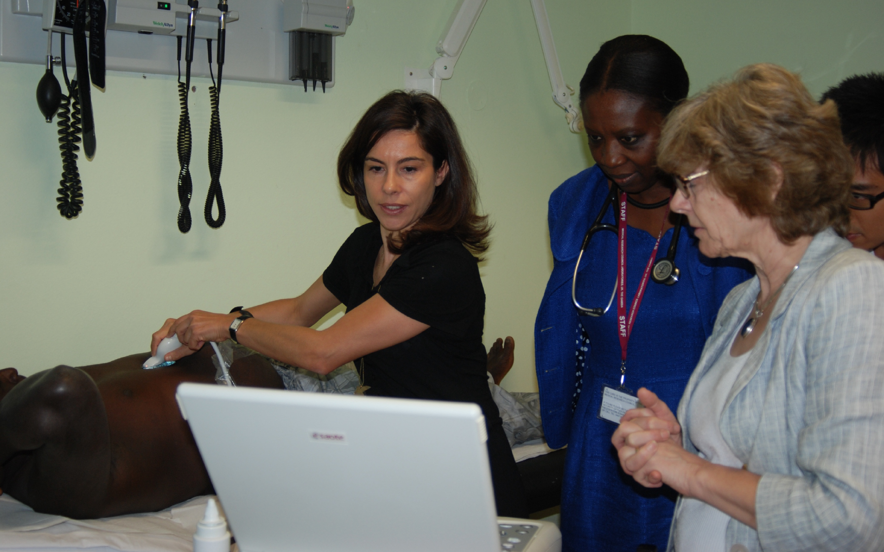 Prof Maud Lemoine using scanning equipment in The Gambia, with Dr Mary Crofton (radiologist at Imperial College Healthcare NHS Trust) and colleagues.