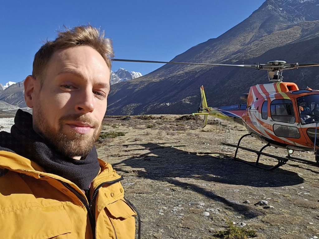 Lewis Turner with helicopter in Himalayas