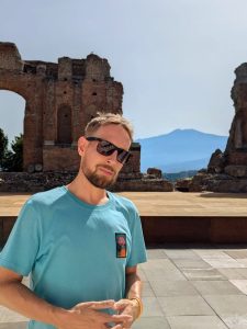 Lewis at Greek theatre in Taormina in Sicily overlooking Mt Etna