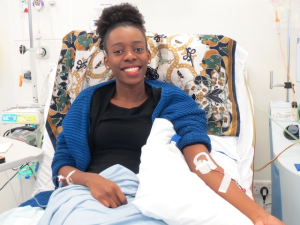 A Black woman in a hospital bed.