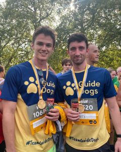 Laurence Gesman and a friend wearing marathon medals