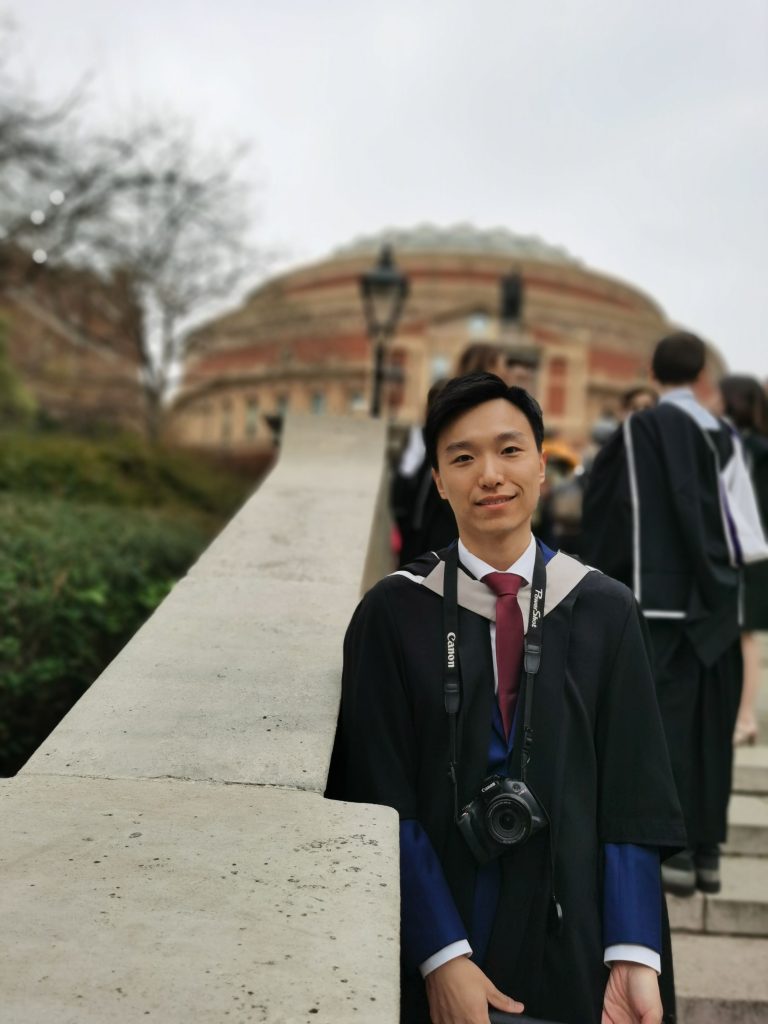 Griffin Gui in graduation robes in front of the Royal Albert Hall