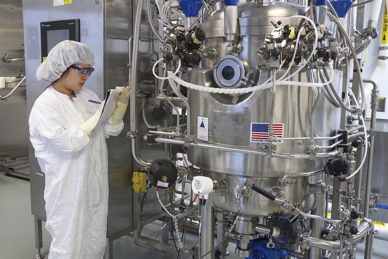 Scientist checking a large biorreactor.