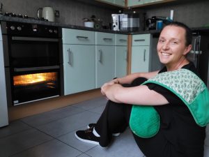 Annemarie, 'Never lick the spoon' podcast cohost, sat next to the oven.