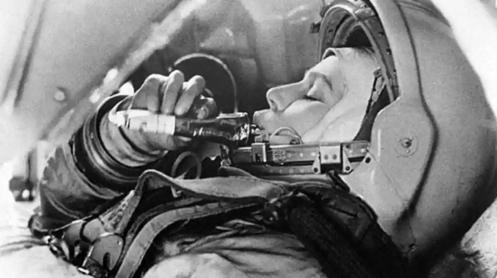 Valentine V Tereshkova, the first woman to go to space, enjoying a fresh tube of meat.
