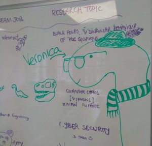 Photo shows doodling in green and purple marker on a whiteboard, and an illustration of the 2019 MLMC Fellowship cohort's diplodocus mascot, Veronica! 