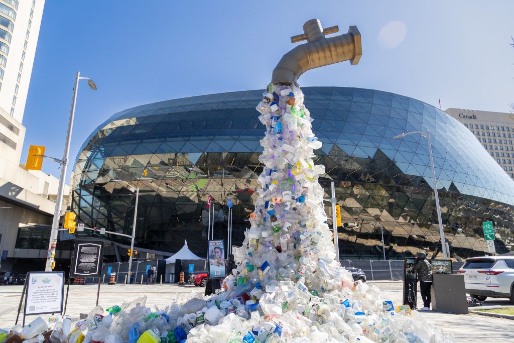 An installation outside the INC-4 conference on plastic being held in Ottawa, Canada.It shows plastic flowing from a water tap.