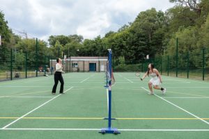 Students playing badminton in the Multi Use Games Area at Silwood Park