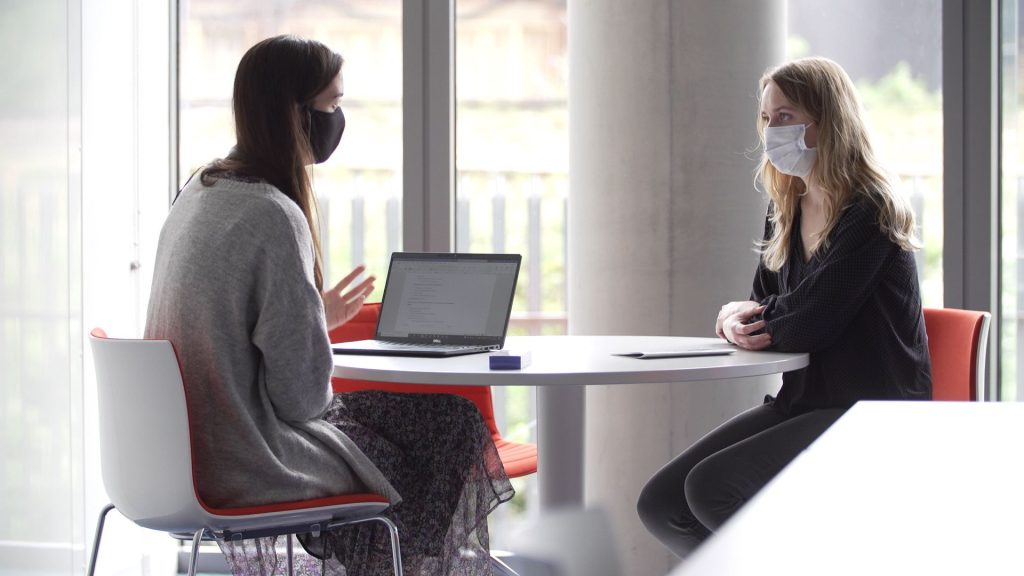 Researchers from the REACT-LC conducts a face to face interview while wearing masks 