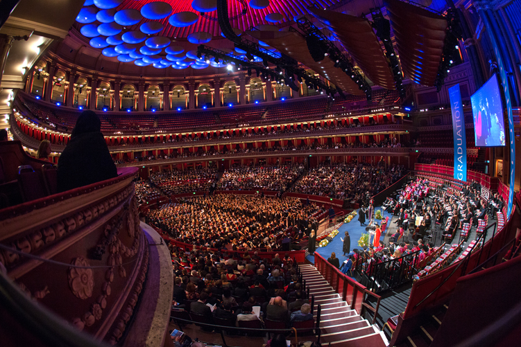 President of Imperial, Professor Alice P. Gast, shakes the hand of a graduating student on the stage at the Royal Albert Hall, while a spectator watches on from the left of the picture. Featued images - Graduation favourites - Imperial College London - Photography blog - Thomas Angus