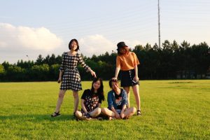 PhD student and friends sitting together in a park