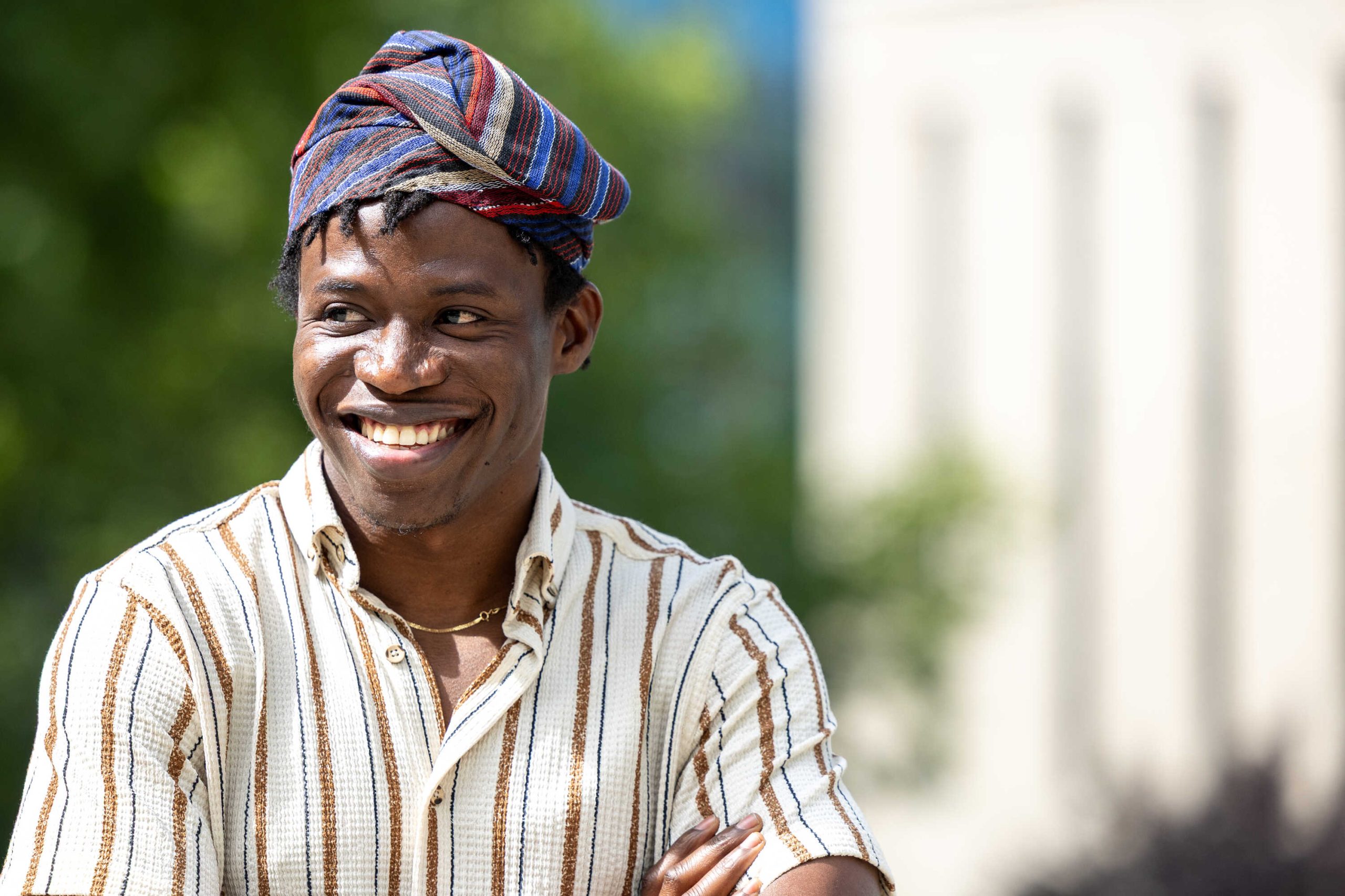 Profile photo of Oluwafemi outdoors in the sunshine, looking off to the left